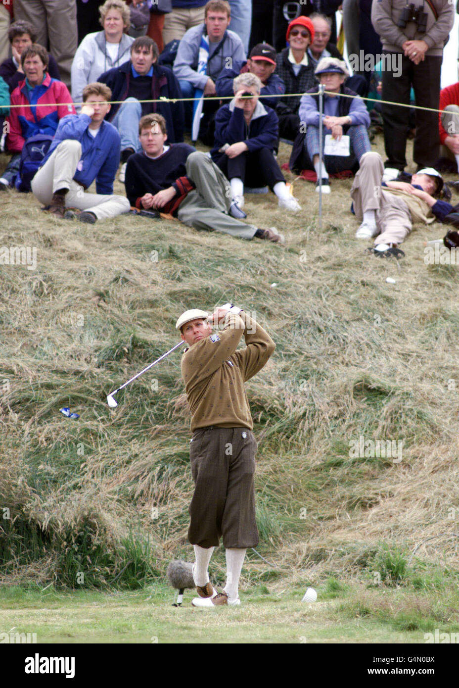 America's Payne Stewart, dressed in a pair of traditional plus fours, plays a shot from the light rough on the 5th hole, during the second day of the 1999 British Open Golf Championship at Carnoustie, Scotland. Stock Photo