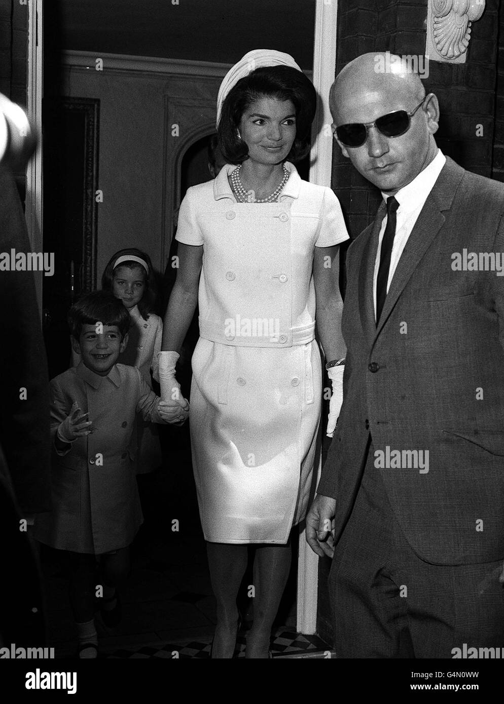 Jackie Kennedy and her children John Jr, 4, and Caroline, 7, leave the home of their Aunt, Princess Radziwill in London, to attend an inauguration of a memorial to the late American President John F Kennedy, unveiled by the Queen. Stock Photo