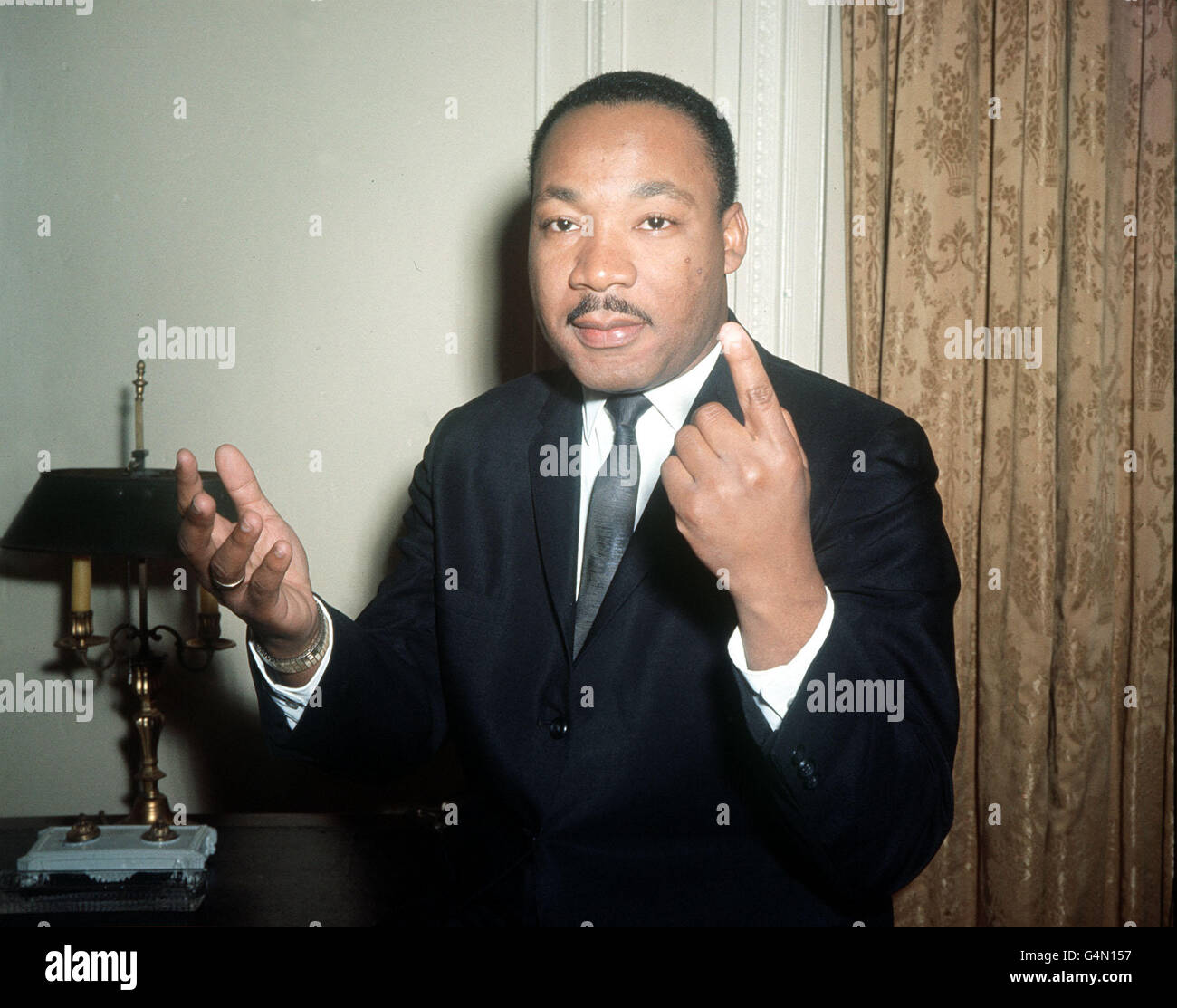 PA News Photo 25/9/64 : Dr. Martin Luther King, the American Black leader gestures as he carries on an animated conversation during a one-day visit to London in connection with the publication of the British version of his latest book on the Civil Rights issue 'Why We Can't Wait' Stock Photo
