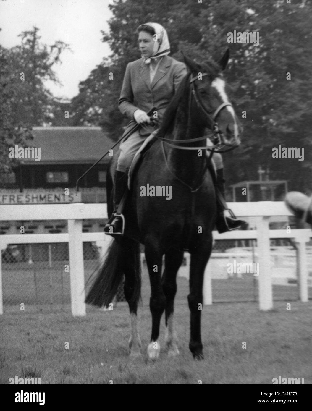 Queen Elizabeth II riding on the racecourse before the opening of the third day of the Royal Ascot meeting. She took part in an unofficial 'race' and finished fourth to other members of her party of seven. Stock Photo