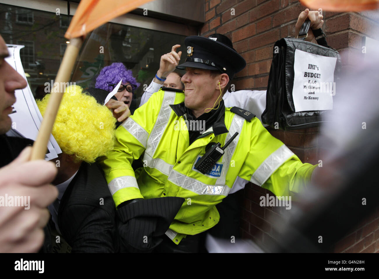 Gardai scuffle with Sinn Fein activists mimicking IMF officials as they picket the European Union headquarters in Dublin as Ireland marks the one year anniversary of the EU/IMF bailout loan. Stock Photo