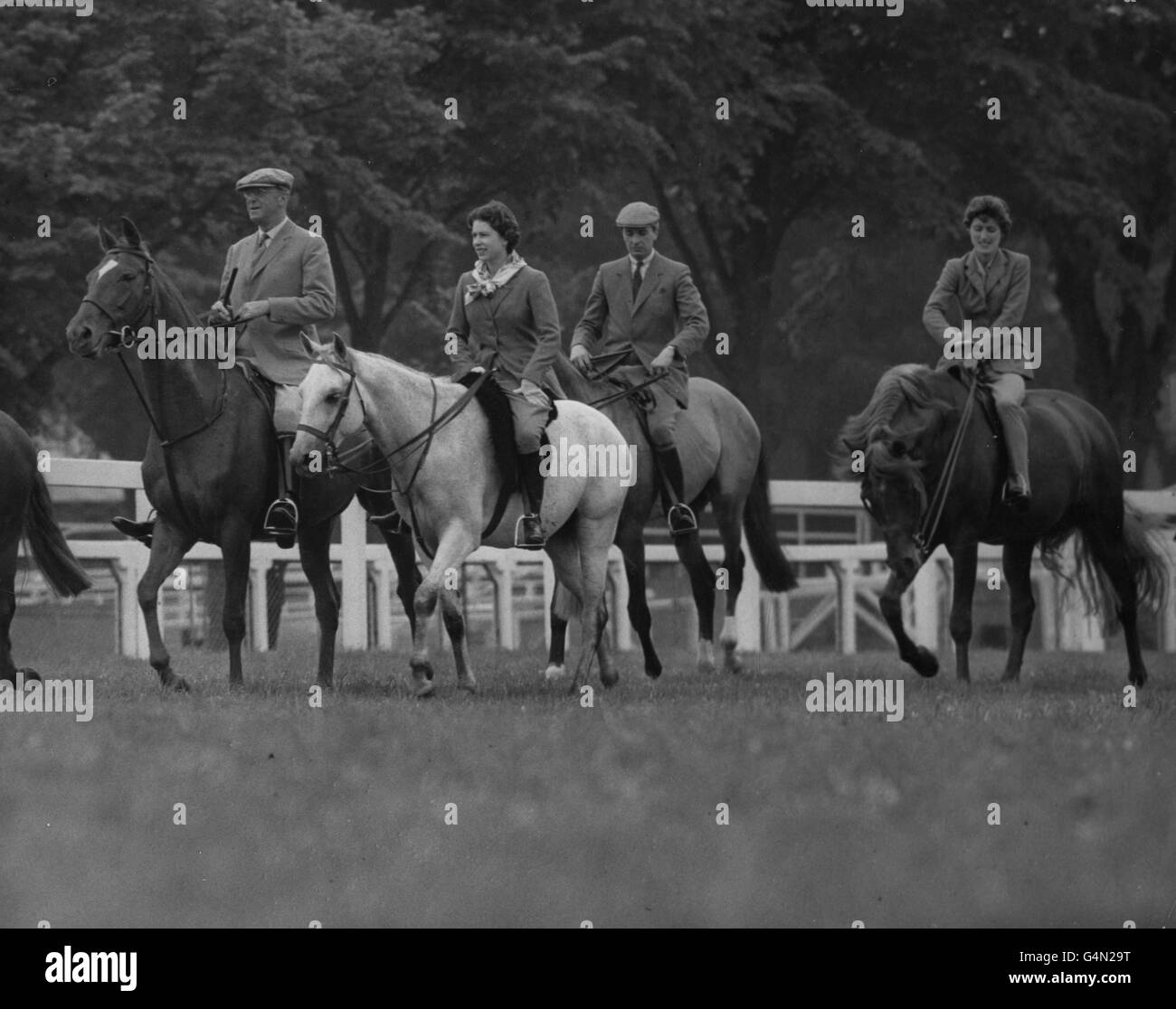 Queen Elizabeth II riding at Ascot with members of her Windsor Castle house party for the Royal Ascot race meeting. Extreme left is the Duke of Beaufort, Master of the Horse. Stock Photo
