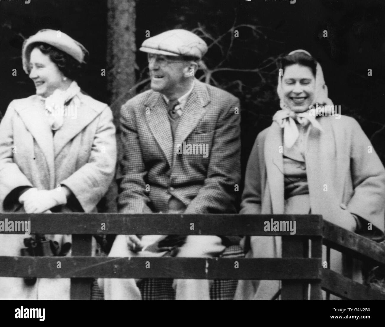 Queen Elizabeth II, the Queen Mother and the Duke of Beaufort use a farm wagon as a 'grandstand' at the Quarry Jump during the Three Day Horse Trials at Badminton. Stock Photo