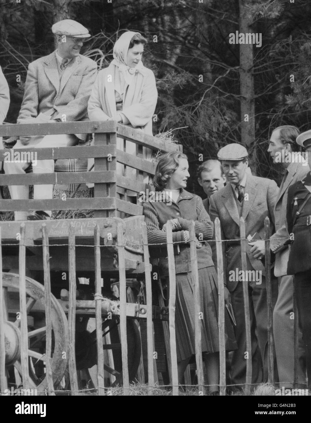 Queen Elizabeth II sits beside her host, the Duke of Beaufort, in a farm wagon used as a grandstand, to watch the endurance tests at the Three Day Horse Trials at Badminton. Stock Photo