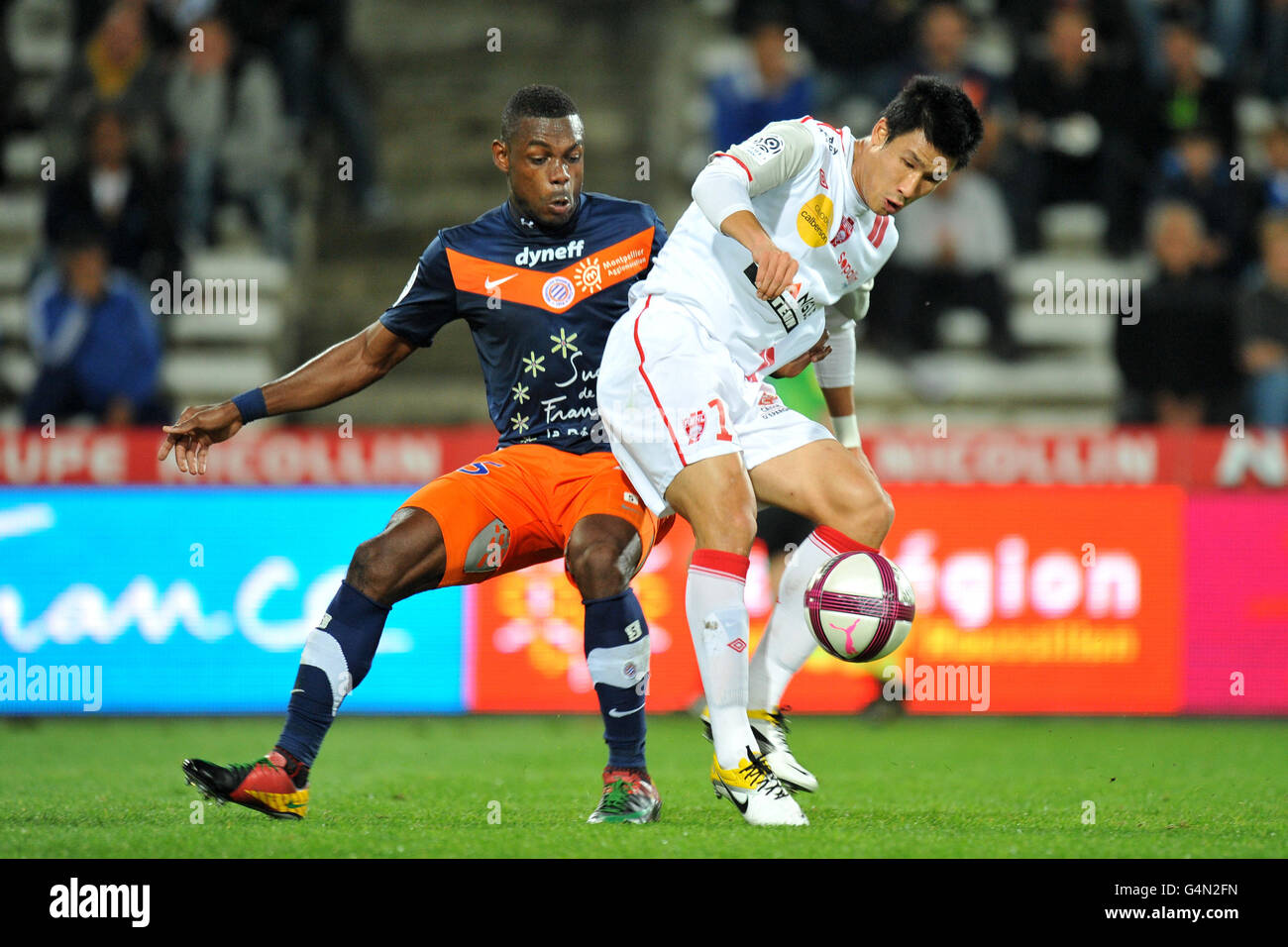 Montpellier's Henri Bedimo Nsame (left) and AS Nancy Lorraine's Jo-gook Jung (right) battle for the ball Stock Photo