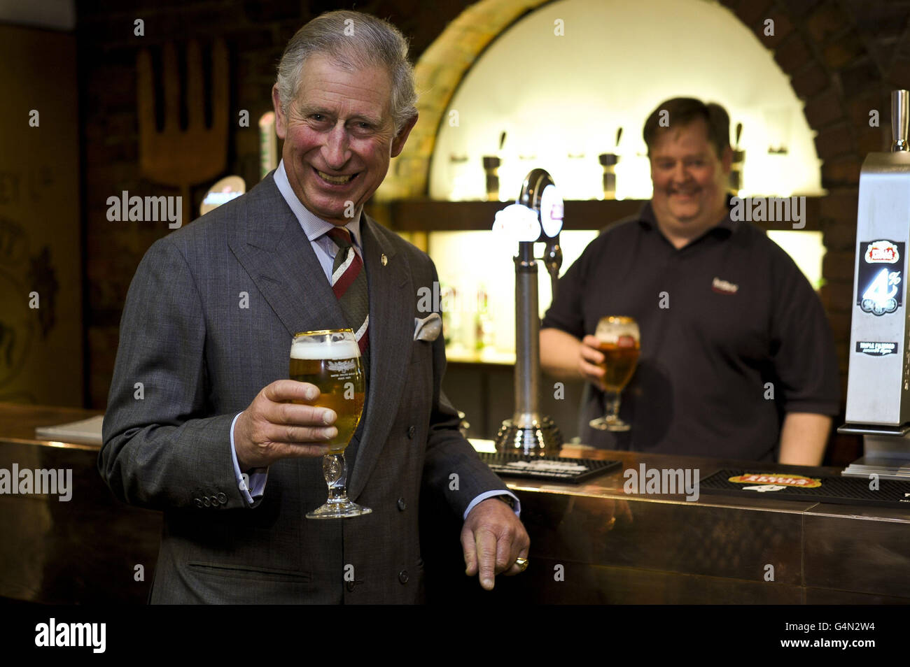 The Prince of Wales is poured a perfect glass of Stella Artois during his visit to the Magor brewery as part of his trip to Gwent. Stock Photo