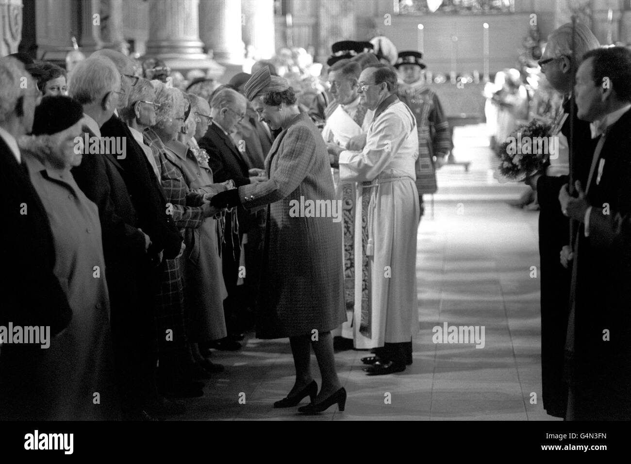 The Queen handing out Maundy Money in the centuries-old tradition at St Philip's Cathedral, Birmingham. Stock Photo