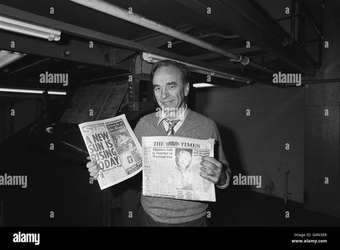 Newspaper proprietor Rupert Murdoch holds copies of The Sun and Times