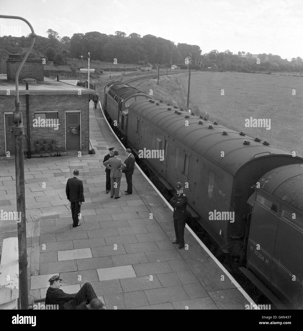 The coaches of the train involved in the 2.5 million mail robbery - the 'Great Train Robbery' - under police guard at Cheddington Station, Buckinghamshire, in August 1963. * 08/08/99: Great Train Robber Ronnie Biggs was reported to be celebrating his 70th birthday, 36 years to the day since the infamous crime which made his name. Biggs, who escaped from Wandsworth Prison in 1965, is reported to be hosting a birthday party at his modest home in Rio de Janeiro, where he has lived beyond the clutches of the British legal system for more than 20 years. 28/3/01: A railway sign from the site of the Stock Photo