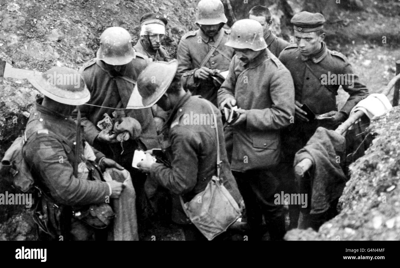 British troops sort through the belongings of German prisoners in a trench, during the first world war. Stock Photo