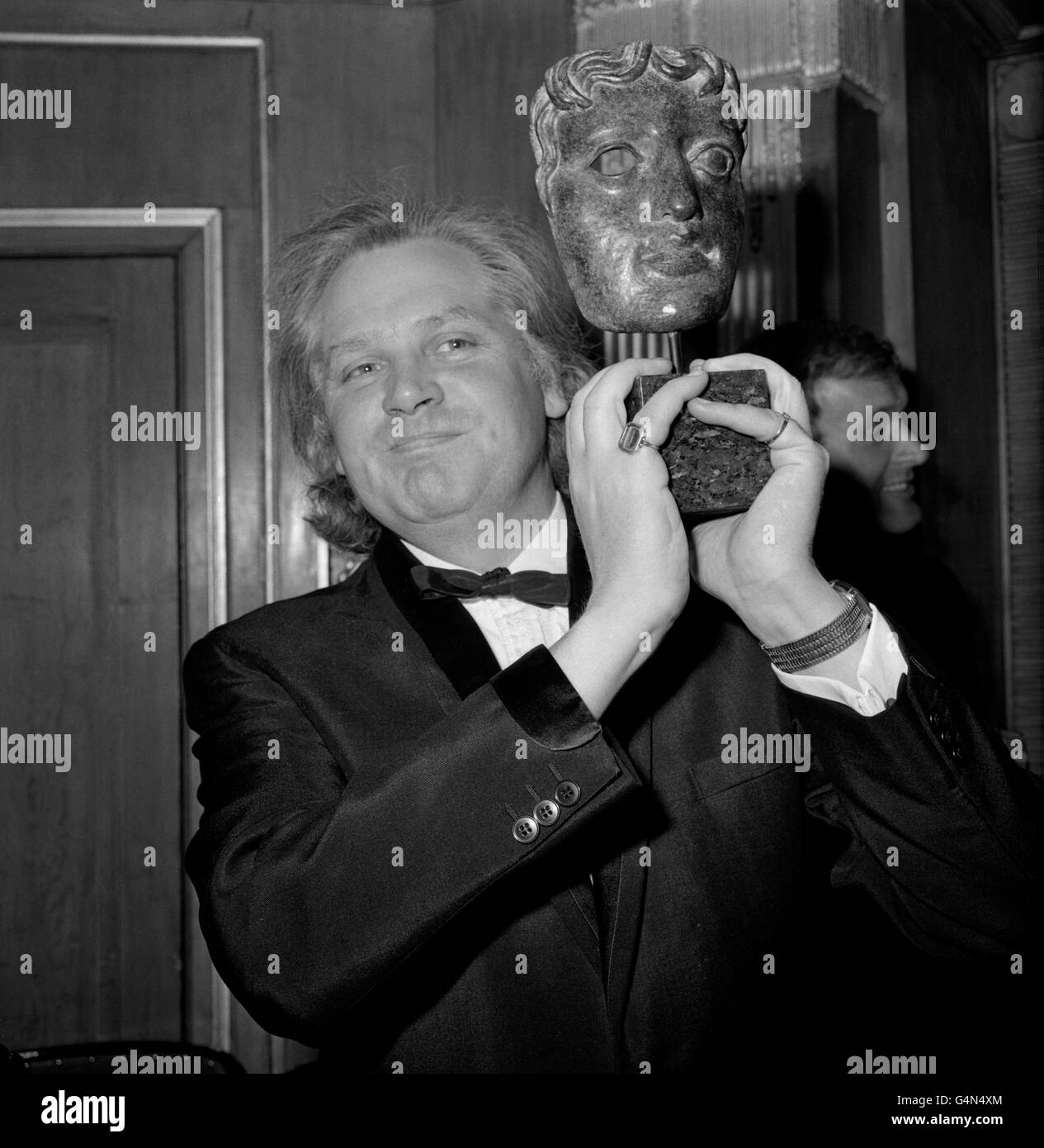 Director Ken Russell, who holds aloft the Desmond Davis Award presented to him at the Guild of Television Producers and Directors Awards Ball at the Dorchester Hotel, London. he was presented the award for his outstanding contribution to documentaries. Stock Photo