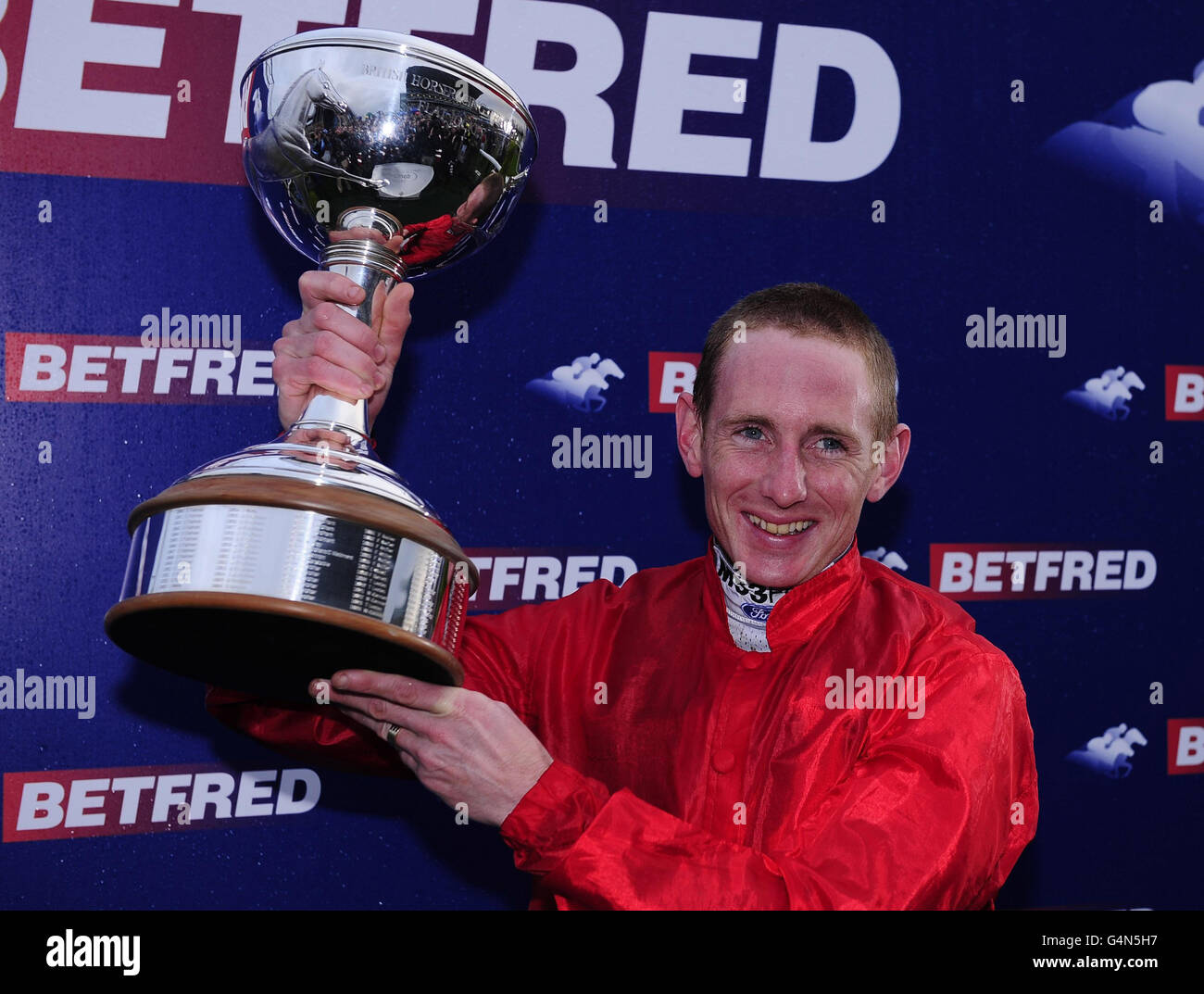 Champion Jockey Paul Hanagan holds the Trophy after the presentation