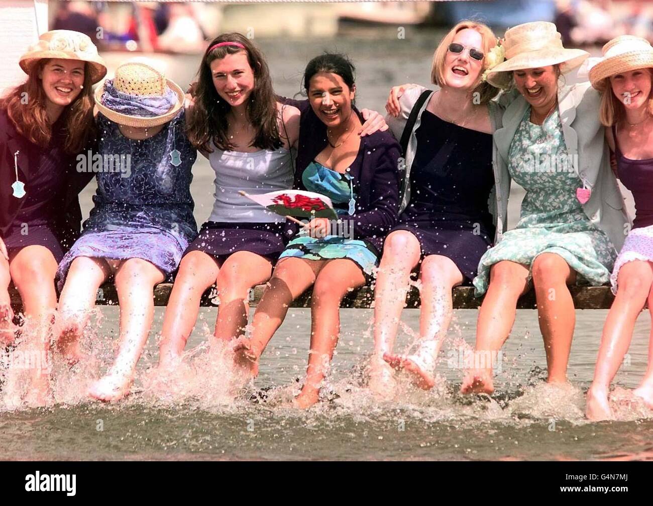 Girls from Haberdasher's Monmouth School for Girls, cool down in the Thames at Henley, Oxfordshire on the first day on the first day of the traditional summer event the 150th Royal Regatta, an annual event. * The Henley Regatta has only been cancelled eleven times in it s history due to the two World Wars, and attracts the world s elite rowers. It is one of the social events of the summer. Stock Photo