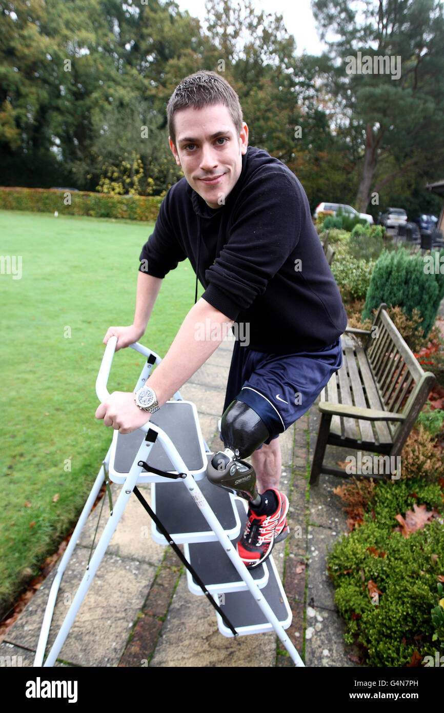 Matthew Newbury stands on a ladder outside ProActive Prosthetics in