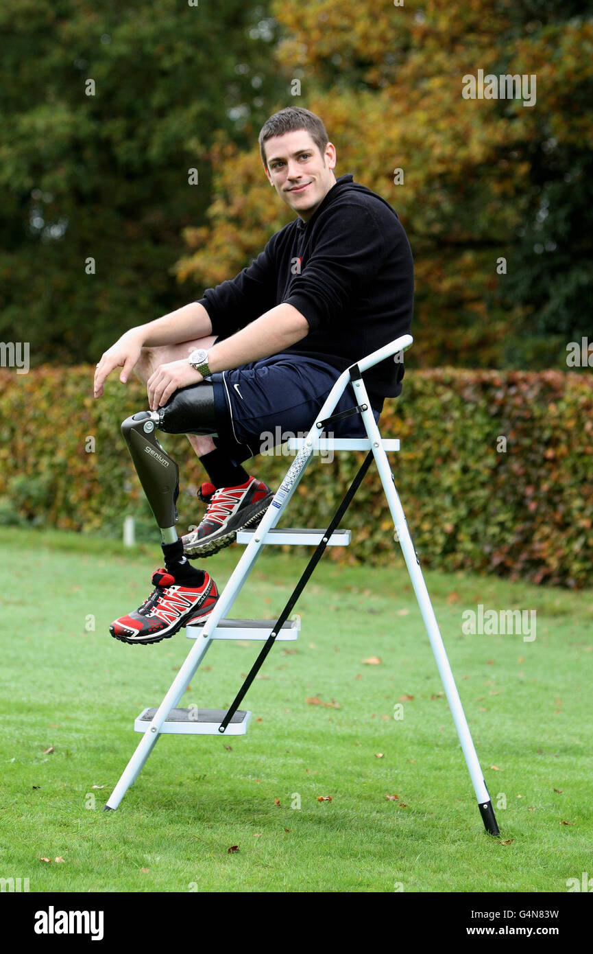 Matthew Newbury sits on a ladder outside ProActive Prosthetics in