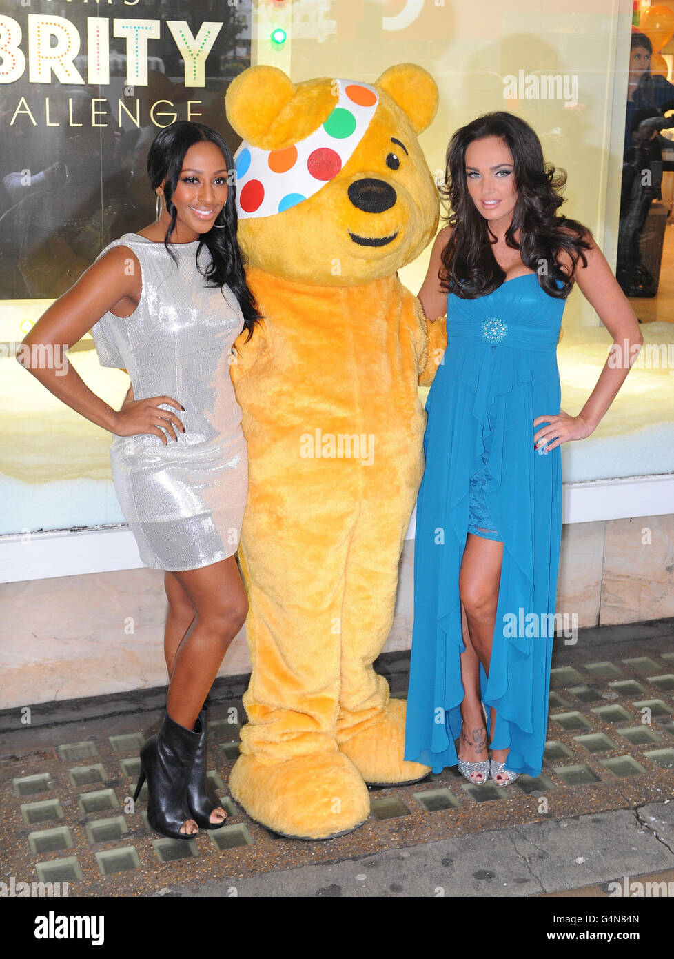 Tamara Ecclestone (right) and Alexandra Burke (left) pose with Pudsey Bear during a photo call outside the Debenhams store on Oxford Street, central London, to launch a fashion collection created for the BBC Children in Need Celebrity Style Challenge. Stock Photo