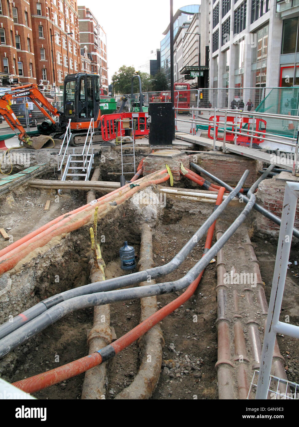 Street excavataion. A networks of pipes, cables and ducts are exposed during roadworks in Victoria, central London. Stock Photo