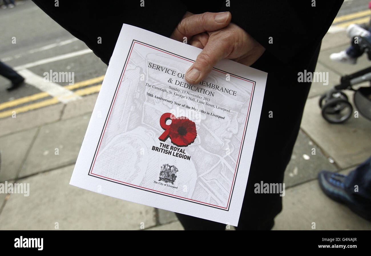 A man holds an Order of Service as hundreds of people attend the annual