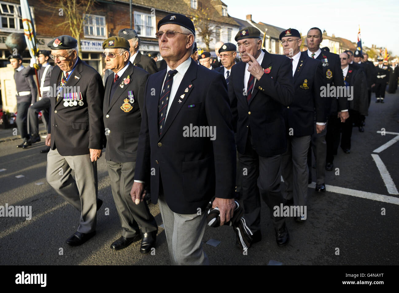 Royal British Legion members march past the war memorial at Royal