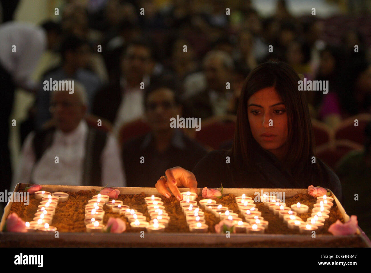 Sneha Hindocha, first cousin to Anni Dewani, lights a candle in her memory at the Shree Kadwa Patidar Samaj in Harrow, to mark her murder one year ago whilst on honeymoon in Cape Town, South Afica. Stock Photo