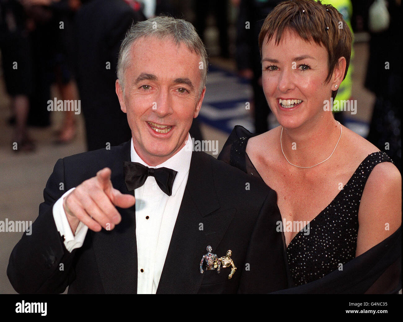 Actor Anthony Daniels (who plays C3PO) and his wife arriving for the Royal Premiere of 'Star Wars Episode 1: The Phantom Menace' at Leicester Square, London. Stock Photo