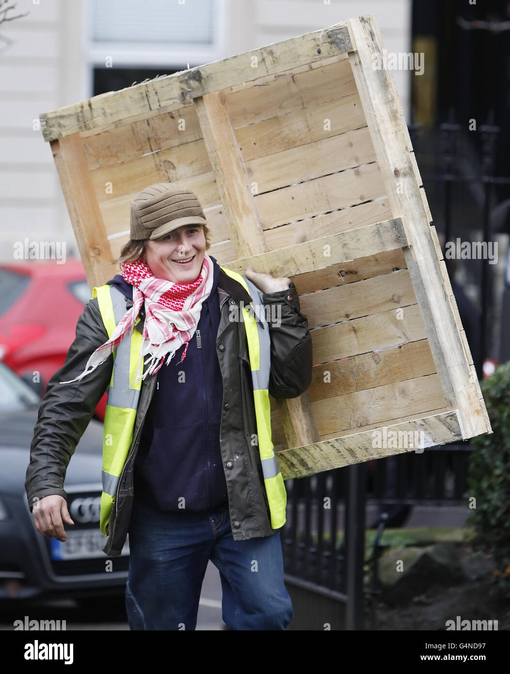 Protester Paddy McManus, carries a wooden pallet at the second Occupy Glasgow camp in Blythswood Square, Glasgow. Stock Photo