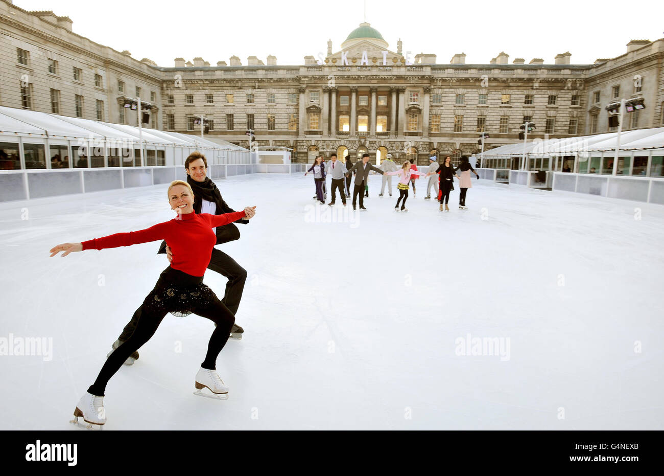 Standalone: British Olympic Ice dance champion Jayne Torvill with James Streeter, as they demonstrate a dance to the 16 members of the Somerset House Ice crew (background), who will guide and support skaters that visit the rink in central London over the winter opening from November 22 until January 22, 2012. Stock Photo
