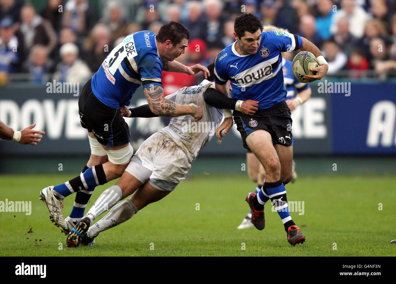 Bath's Stephen Donald (right) escapes the tackle of Montpellier's Paul Bosch during the Heineken Cup match at the Recreation Ground, Bath. Stock Photo