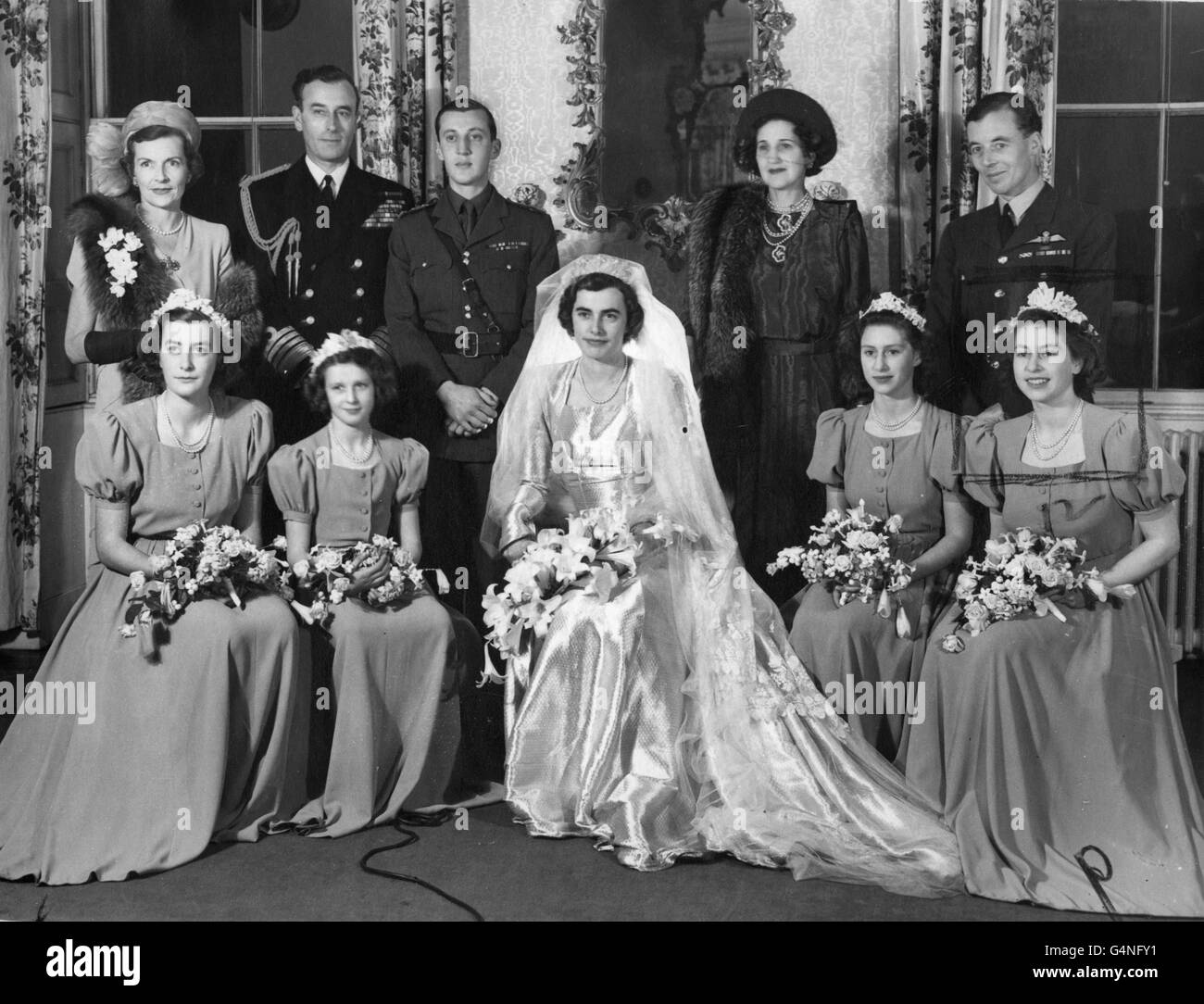 The wedding group at the reception held at Broadlands, the Mountbatten home. Back row, left to right; Countess Mountbatten; Earl Mountbatten; the groom, Lord Brabourne; Baroness Brabourne and the best man Squadron leader Charles Harris St. John. Front row, seated, left to right; the Hon. Pamela Mountbatten, sister of the bride; Princess Alexandra of Kent; the bride the Hon. Patricia Mountbatten; Princess Margaret; and Princess Elizabeth. Stock Photo