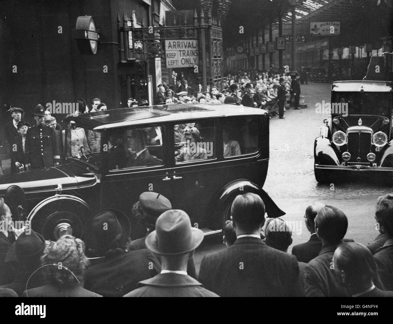 King George VI, Princess Elizabeth and Princess Margaret in the royal car leaving Euston Station after arriving back in London from Balmoral. Stock Photo