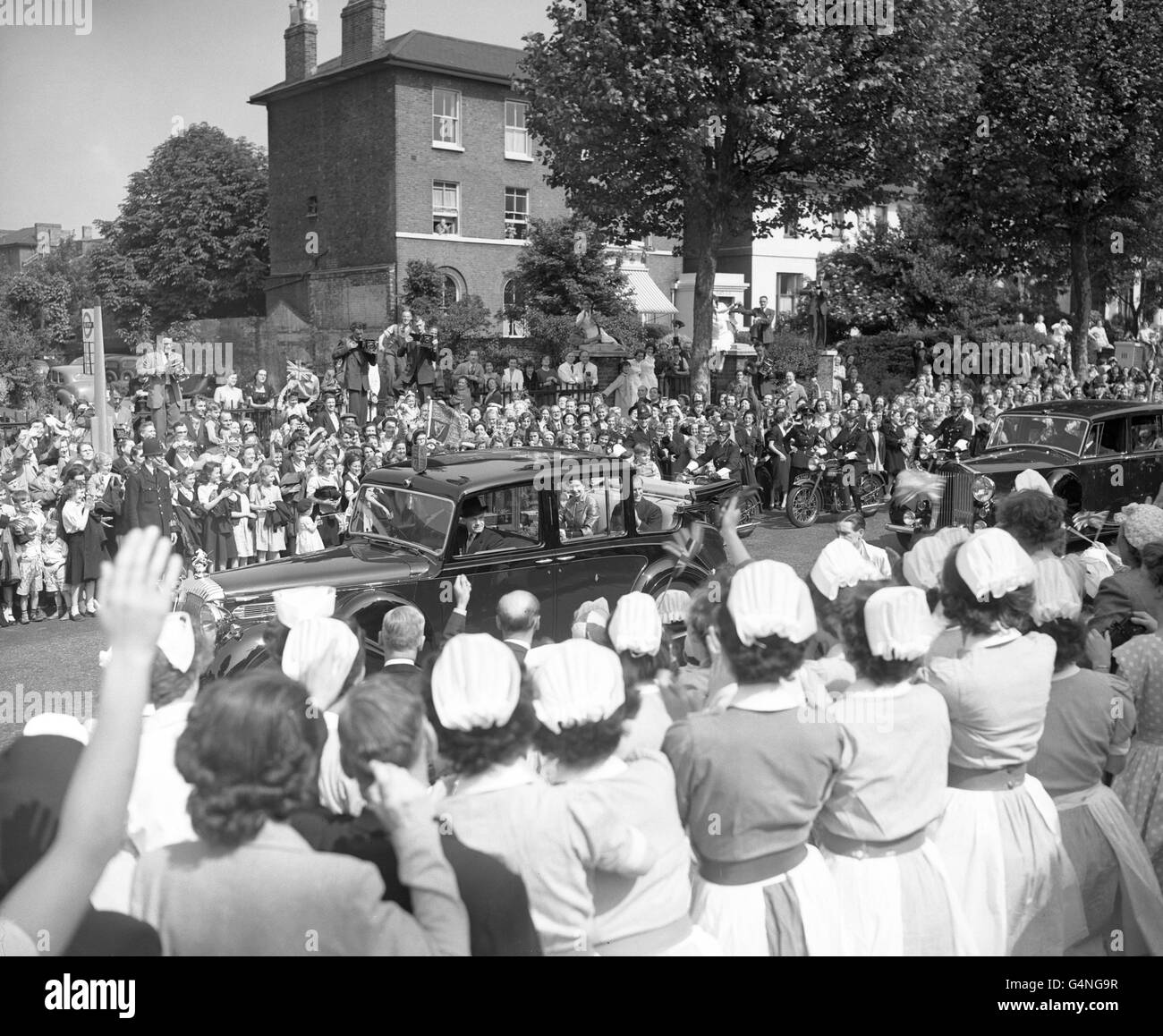 Nurses join in the cheers as Queen Elizabeth II and the Duke of Edinburgh pass King's College Hospital, Denmark Hill, during their drive through south west London. Stock Photo