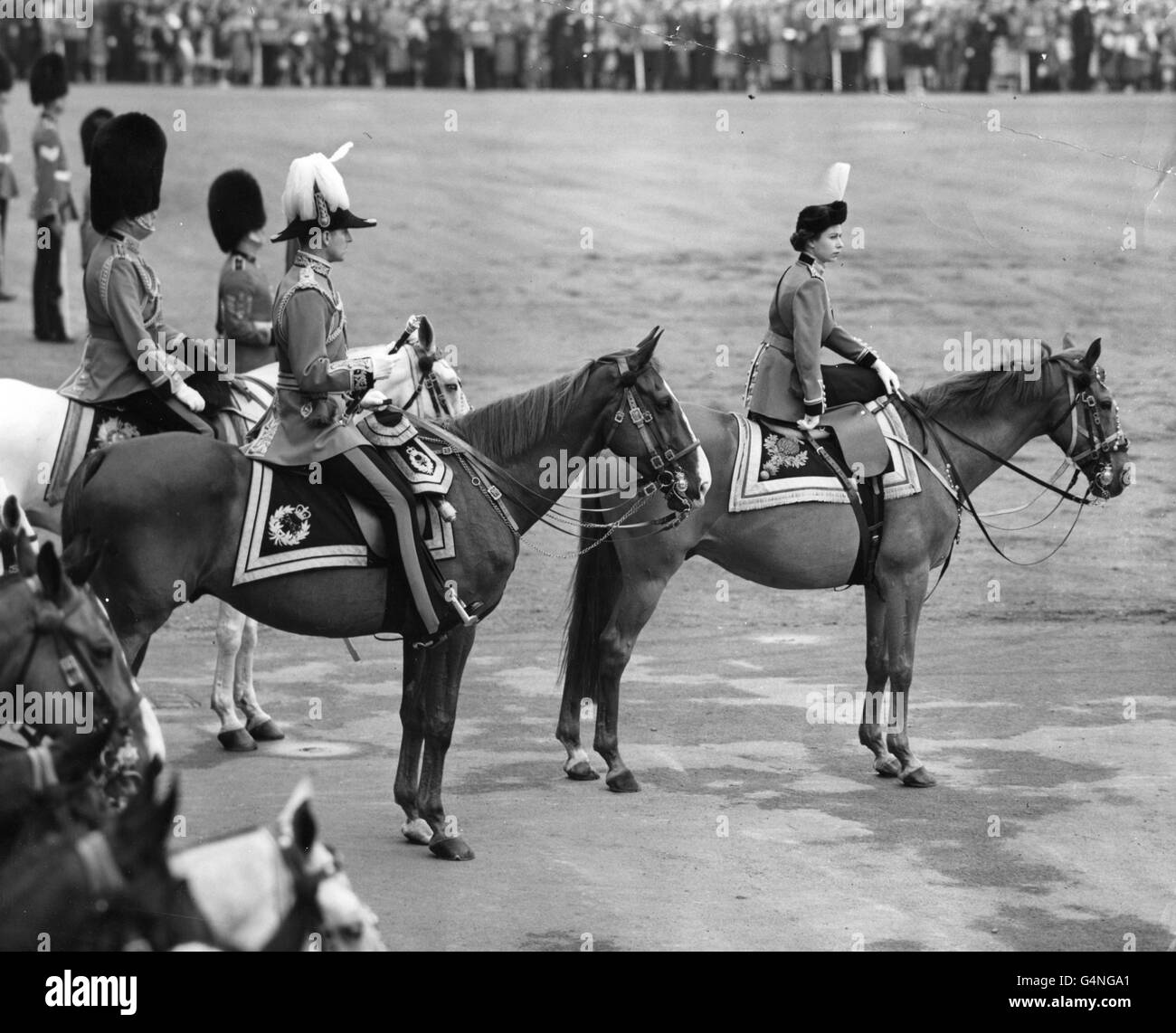 Queen Elizabeth II, riding her horse Winston, taking the salute at Horse Guards Parade. On the left is the Duke of Edinburgh, in Field Marshall uniform, and extreme left is the Duke of Gloucester in the uniform of the Colonel-in-Chief of the Scots Guards. Stock Photo