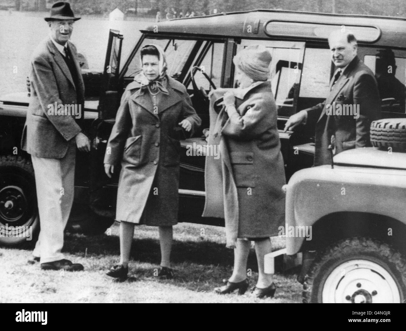 Queen Elizabeth II, with the Queen Mother leave their Land Rover on arrival at the Badminton Horse Trials. With them is the Duke of Beaufort, left. Stock Photo