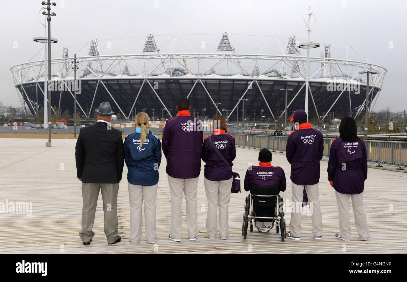(left-right) John Askew, Louise Matthews (Technical uniforms), Rheiss Brown, Helen Gist, Jayant Mistery, Lade Adanijo and Rita Patel (Game Makers uniforms) during the photocall at the Olympics Park, London. Stock Photo