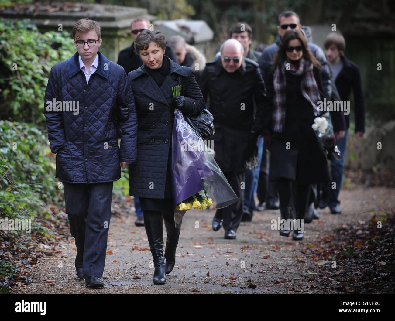 Marina Litvinenko, the widow of Alexander Litvinenko who died exactly five years ago, carries flowers as she walks with her son, Anatoly, 16, to mark the anniversary of her husbands death, at Highgate Cemetery in north London. Stock Photo