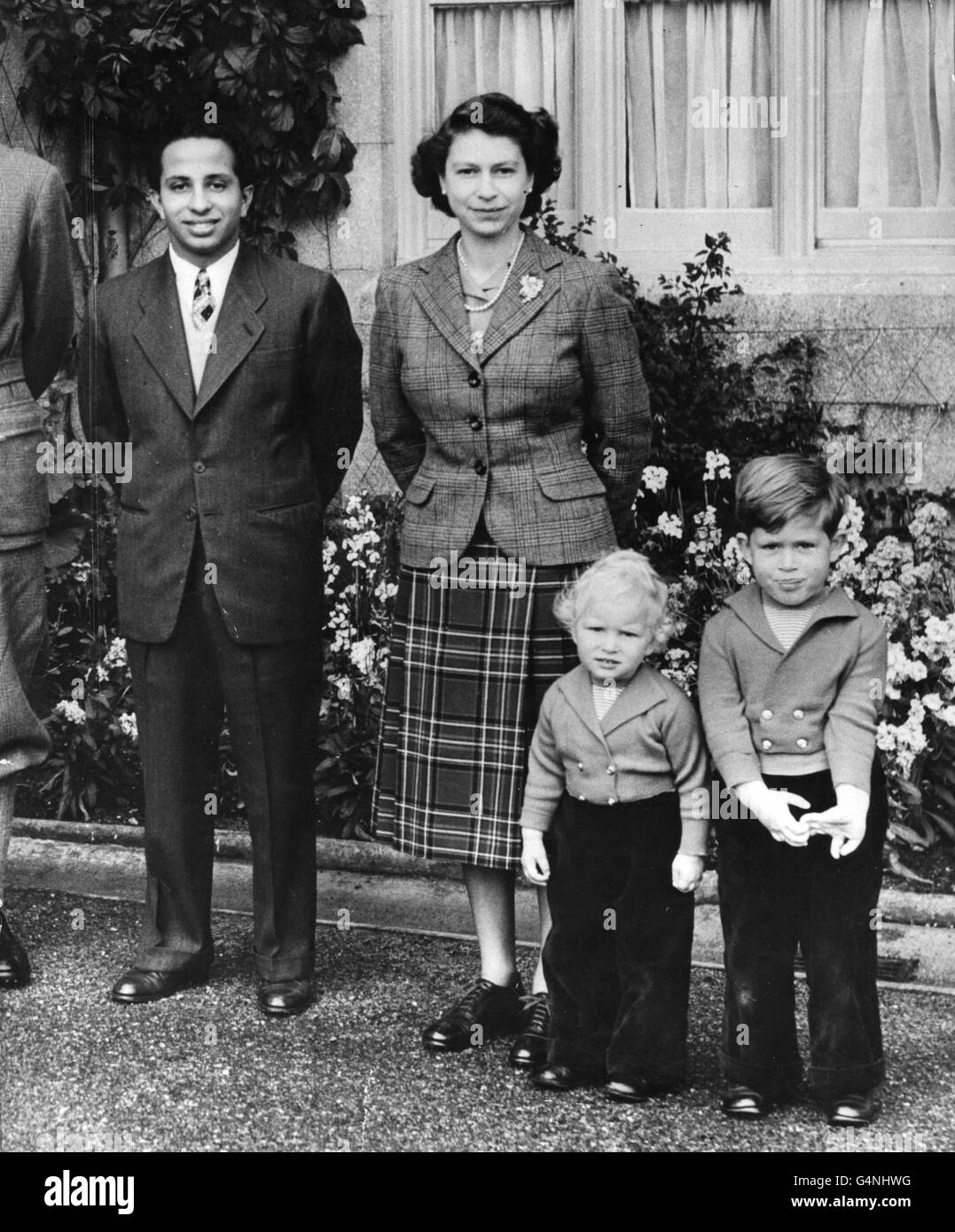 Queen Elizabeth II, outside Balmoral Castle with her Royal visitor, King Faisal II of Iraq, and Princess Anne and Prince Charles. Stock Photo