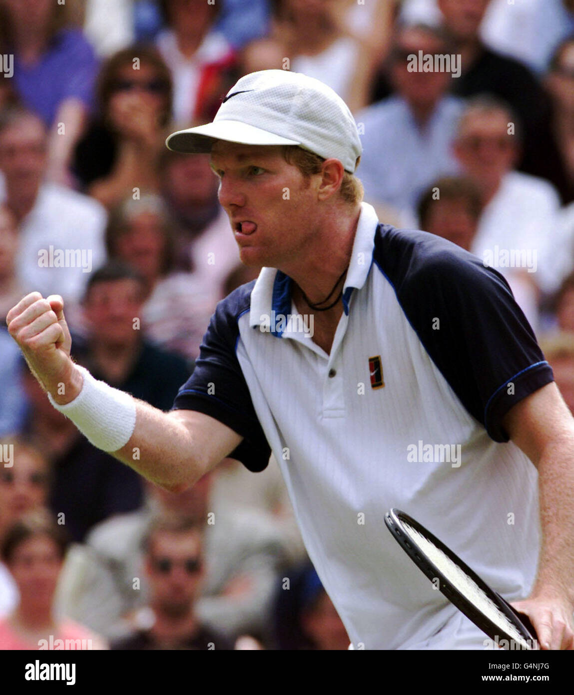 American Jim Courier celebrates after winning another set during his match at Wimbledon against Tim Henman. Henman defeated Courier 4-6, 7-5, 7-5, 6-7, 9-7. Stock Photo