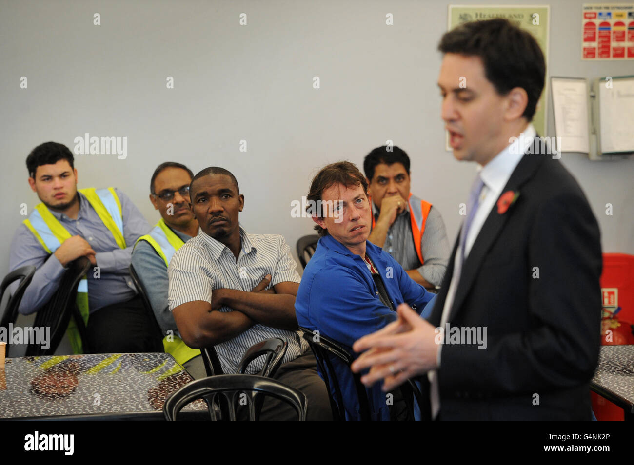 Labour leader Ed Miliband speaks to apprentices and staff at manufacturing firm Kesslers International, who make shop display units in Stratford, east London. Stock Photo