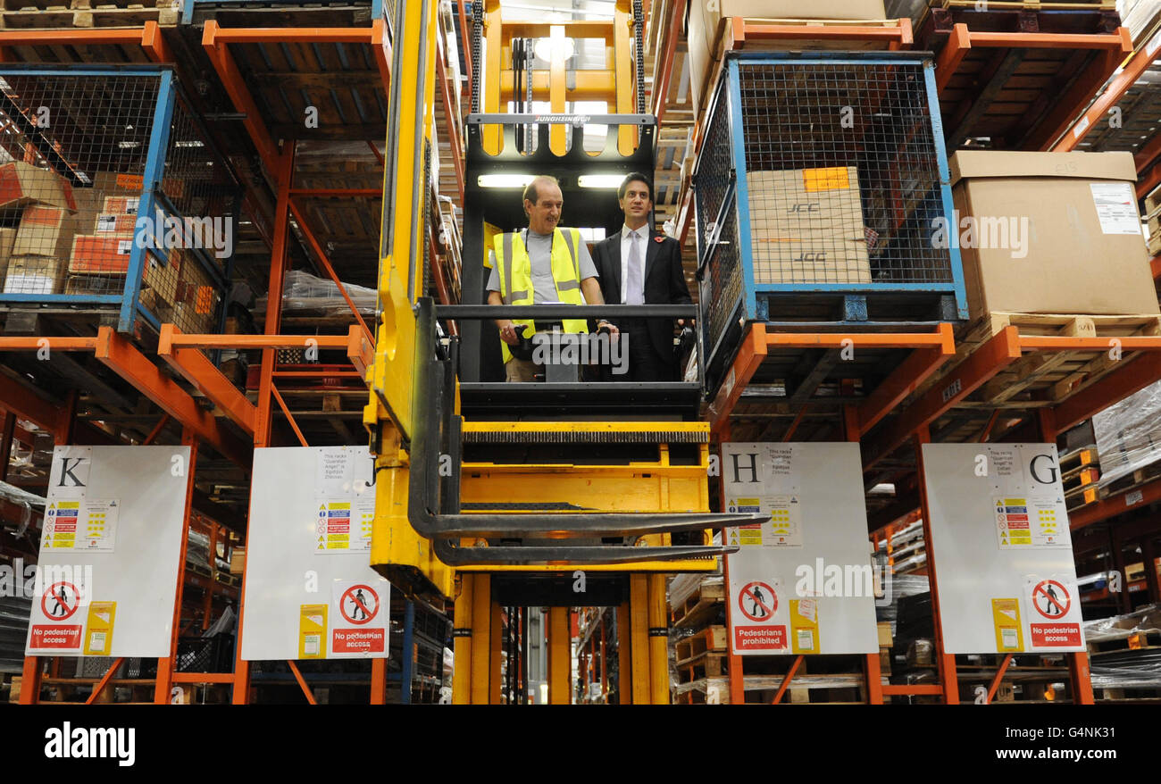Labour leader Ed Miliband rides on a fork lift at manufacturing firm Kesslers International, who make shop display units in Stratford, east London. Stock Photo