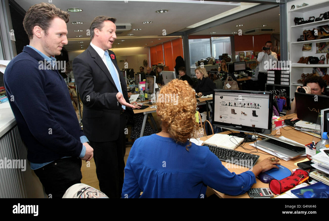 Prime Minister David Cameron speaks to employees during a visit to internet company Stylist Pick in Clerkenwell, London, after he challenged smaller firms to get out of their 'comfort zone' and export goods abroad as he announced that £95 million is to be made available for investment. Stock Photo