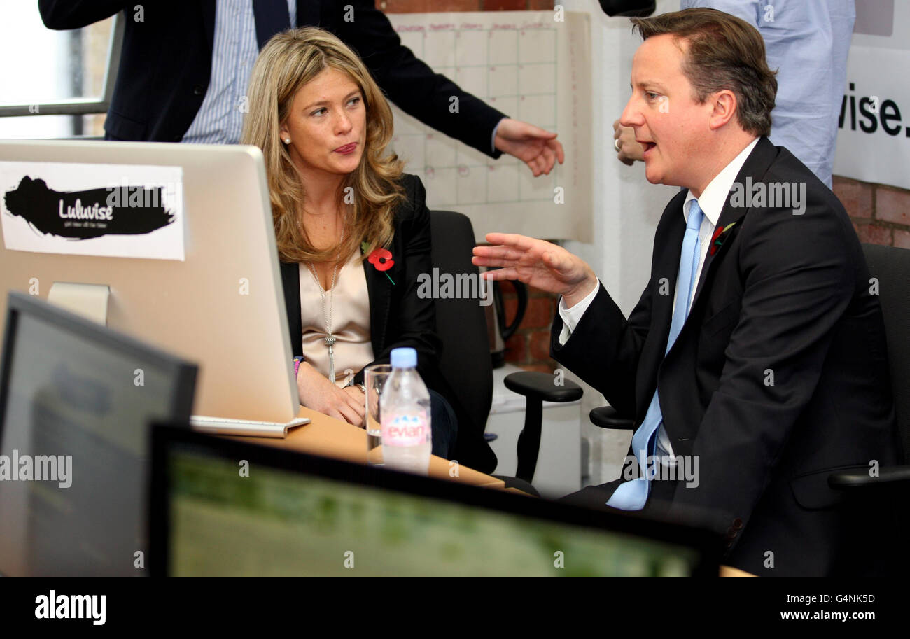 Prime Minister David Cameron chats to Luluvise CEO Alexandra Chong during a visit to the internet company in Clerkenwell, London, after he challenged smaller firms to get out of their 'comfort zone' and export goods abroad as he announced that &pound;95 million is to be made available for investment. Stock Photo