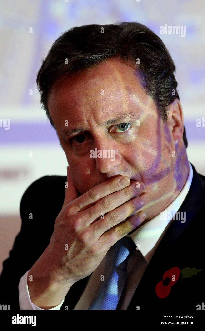 Prime Minister David Cameron sits in front of an interactive map during a visit to internet company The Trampery in Shoreditch, London, after he challenged smaller firms to get out of their 'comfort zone' and export goods abroad as he announced that £95 million is to be made available for investment. Stock Photo