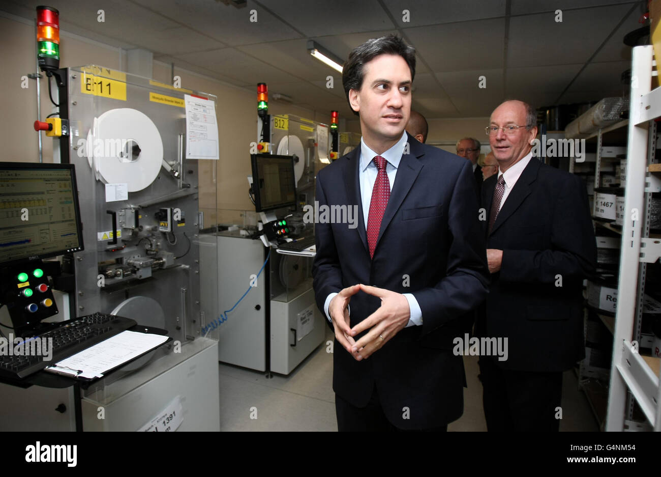 Labour Party leader Ed Miliband walks with Managing Director of TTP LabTech Dr Philip Blenkinsop during a visit to TTP group in Melbourn, Cambridgeshire. Stock Photo