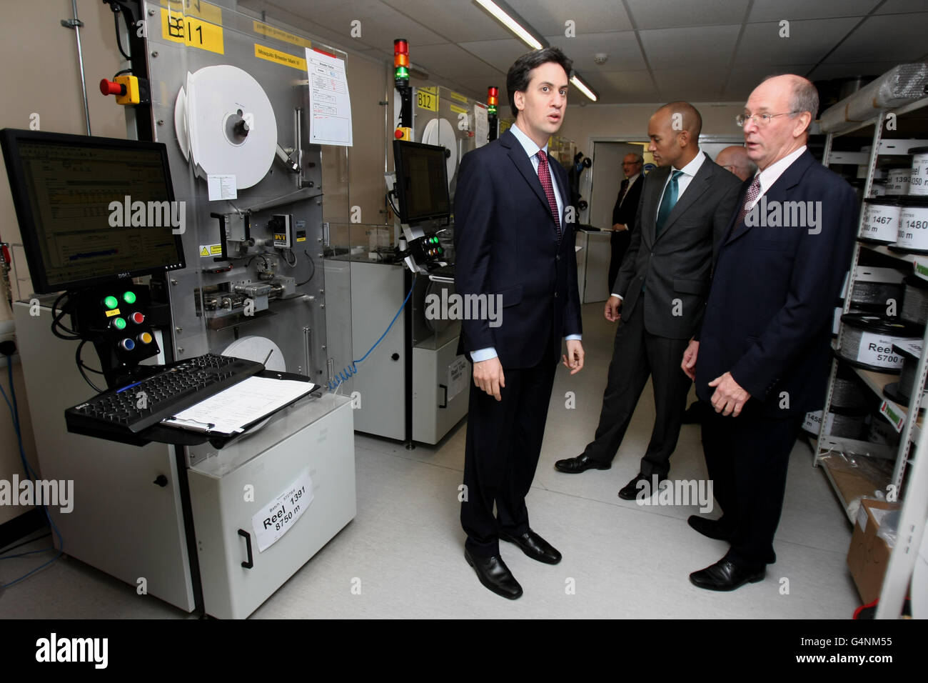 Labour Party leader Ed Miliband (left) and Shadow Business Secretary Chuka Umunna (centre) speak with Managing Director of TTP LabTech Dr Philip Blenkinsop during a visit to TTP group in Melbourn, Cambridgeshire. Stock Photo