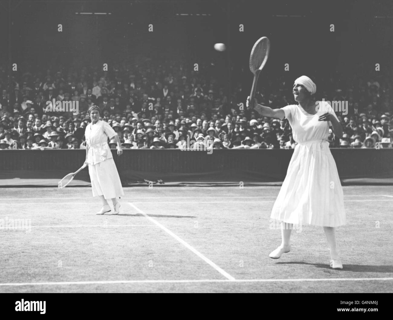Mlle. Lenglen and Miss Ryan beating Mrs Larcombe and Mrs Lambert Chambers in the finals of the Ladies Doubles at Wimbledon for the World's Championship. Stock Photo