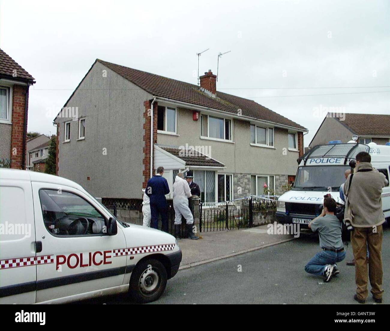 Police forensic experts arrive at a house in Heol Undeb, Yorkdale, at Beddau, South Wales, where inquiries were continuing into the death of two young brothers and their father found dead in a parked car in woodland. * Officers called to a country lane last night near Pontypridd, South Wales smashed a window of the vehicle but the occupants were dead when they reached East Glamorgan Hospital the night of 2/8/99. Stock Photo