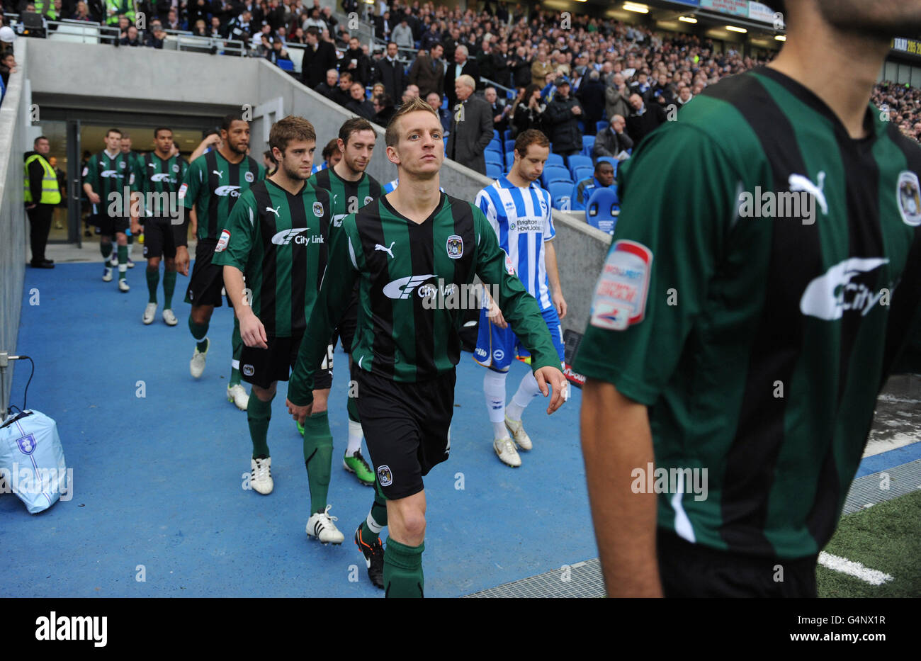 The players of Brighton & Hove Albion and Coventry City teams enter the pitch ahead of the npower Football League Championship match at the AMEX Stadium, Brighton. Stock Photo