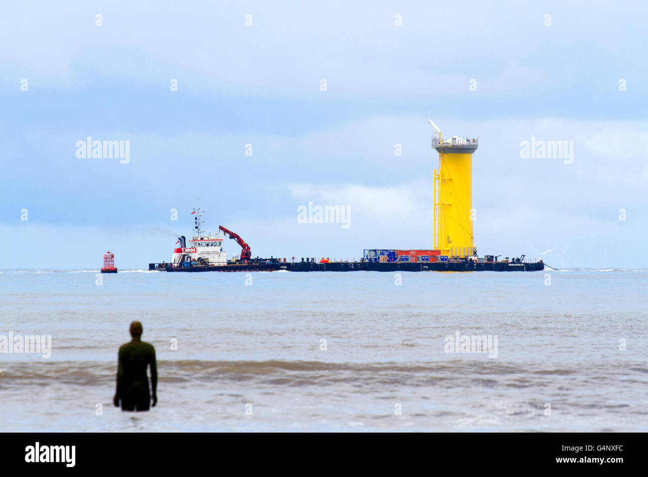 Shipping leaving the River Mersey, crossing the Burbo Windfarm, at Crosby, Merseyside, UK. Cammell Laird Wind Farm components. Stock Photo