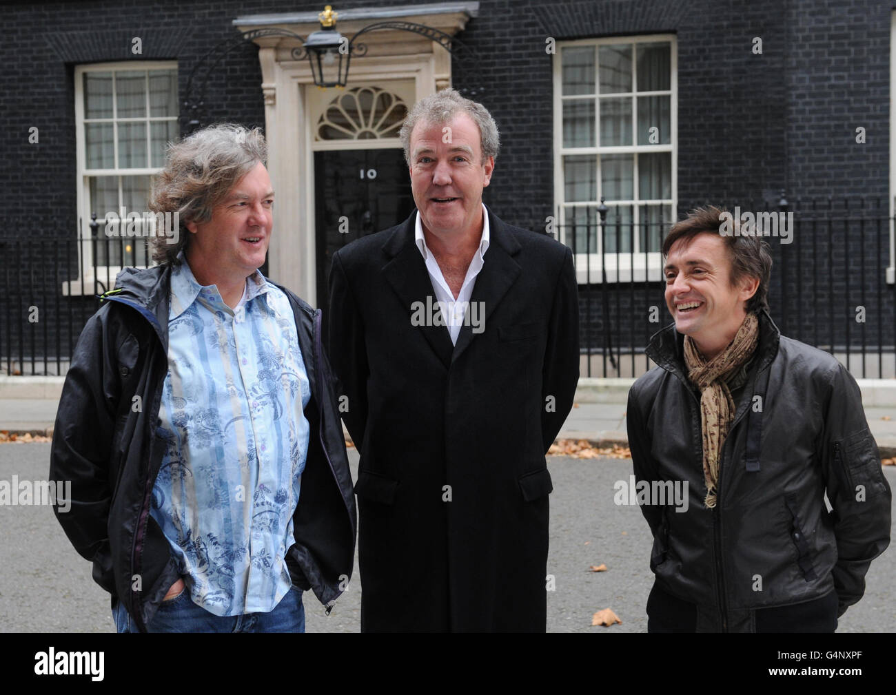 Presenters of the television car show Top Gear from left James May, Jeremy Clarkson and Richard Hammond outside 10 Downing Street in London, where they were filming an episode of the BBC's Top Gear show. Stock Photo