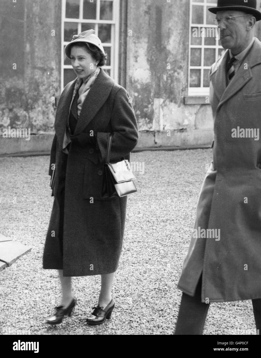 Queen Elizabeth II, accompanied by the Duke of Beaufort, walks from Badminton House to watch the dressage at the British Horse Society's Badminton Horse Trials. Stock Photo